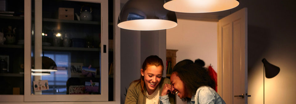 Two young woman sitting at a well lit table