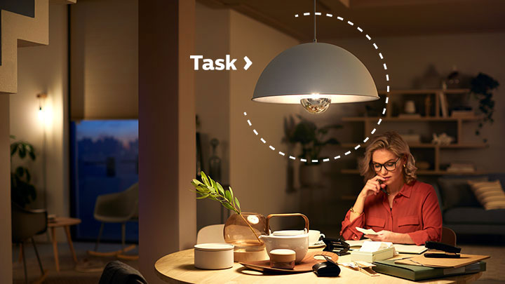 Woman working under a Philips LED mirror bulb