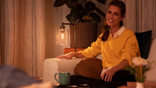 Woman enjoying dimmed light on a sofa at home